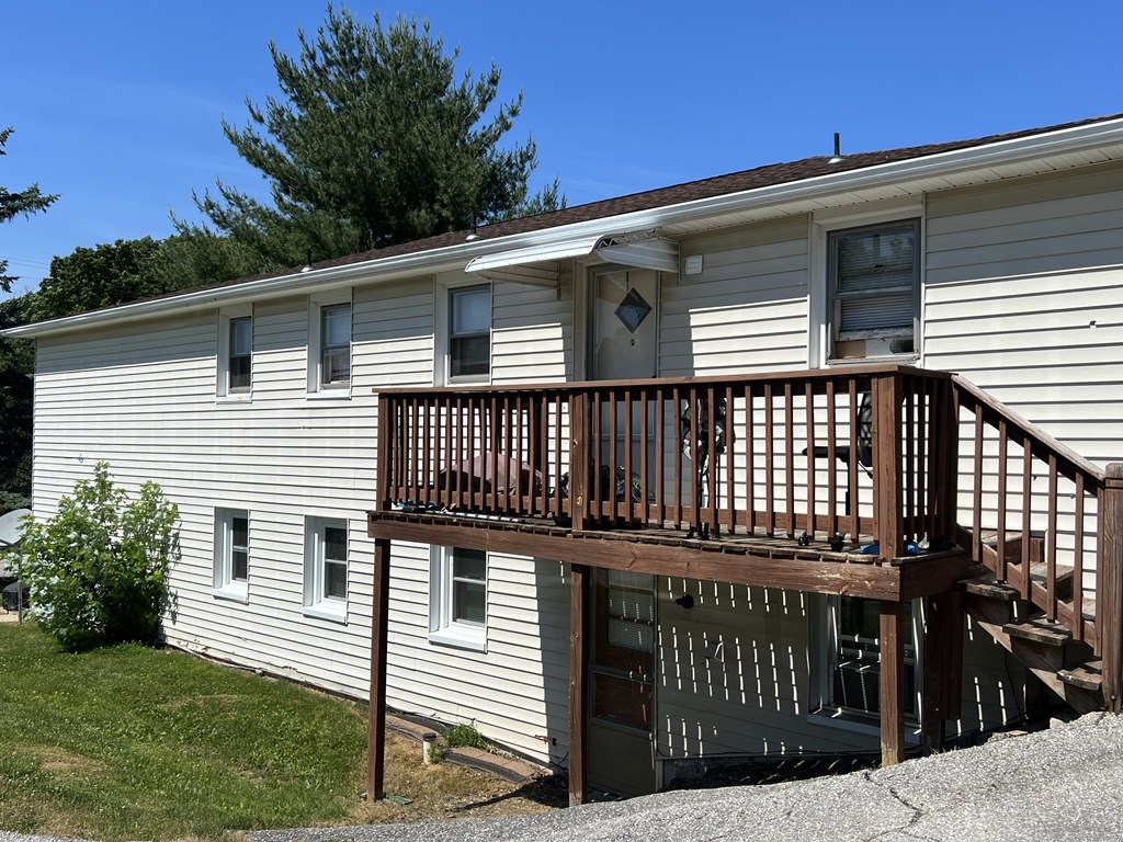 A house with a brown deck and a brown door.