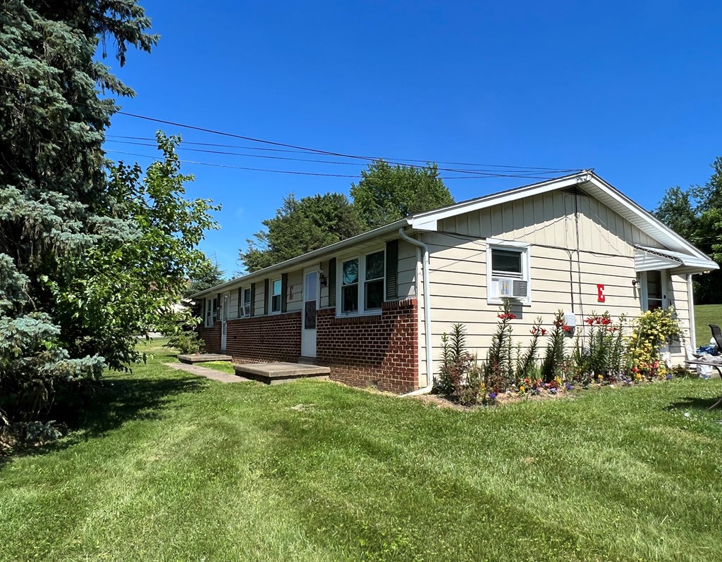 A house with a green lawn in front.