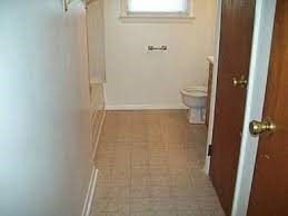 A bathroom with a toilet and a door.
