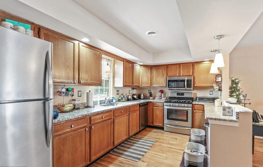 A kitchen with wooden cabinets and stainless steel appliances.