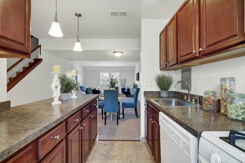 A kitchen with brown cabinets and a white stove top oven.