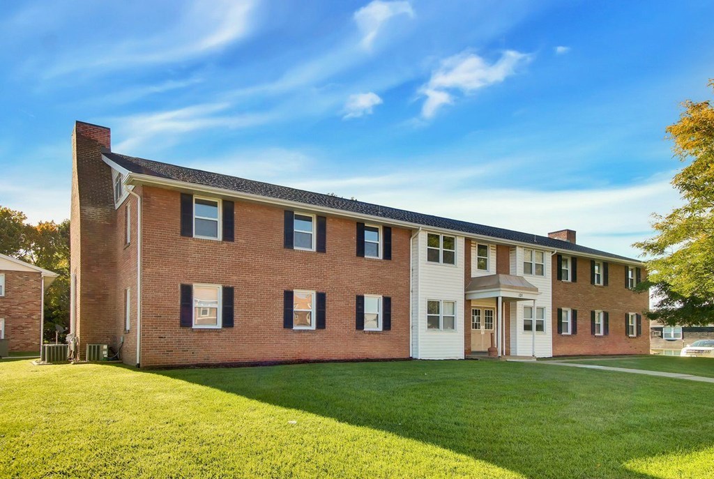 A large brick building with a white door and windows.