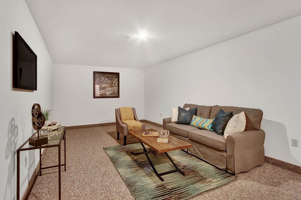 A living room with a couch, chair, and coffee table.