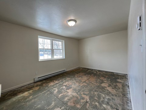 A room with a window and a ceiling light.