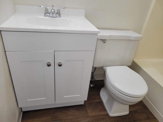 A white toilet sits next to a sink in a bathroom.
