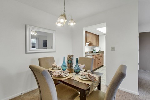 A dining room with a table set for two.
