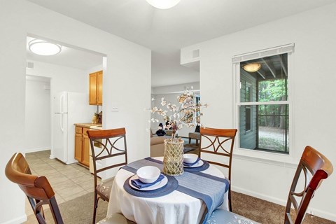 A dining room with a table set for two.