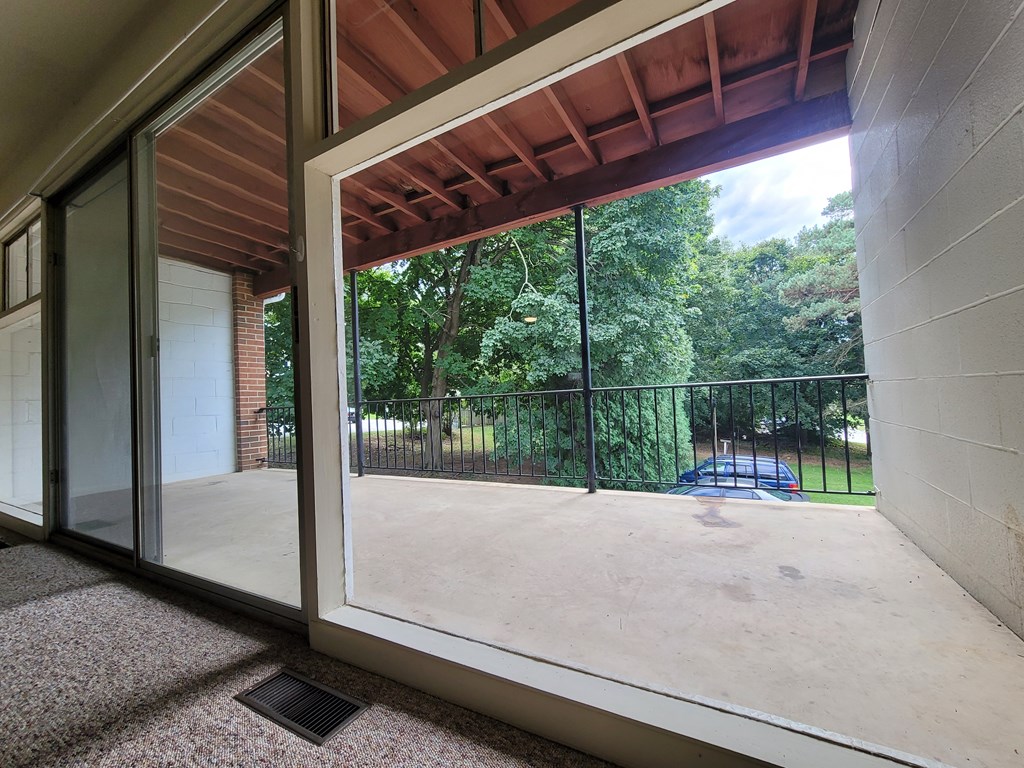 A view from inside a building looking out through a sliding glass door.