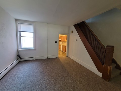 A room with a staircase and a window.
