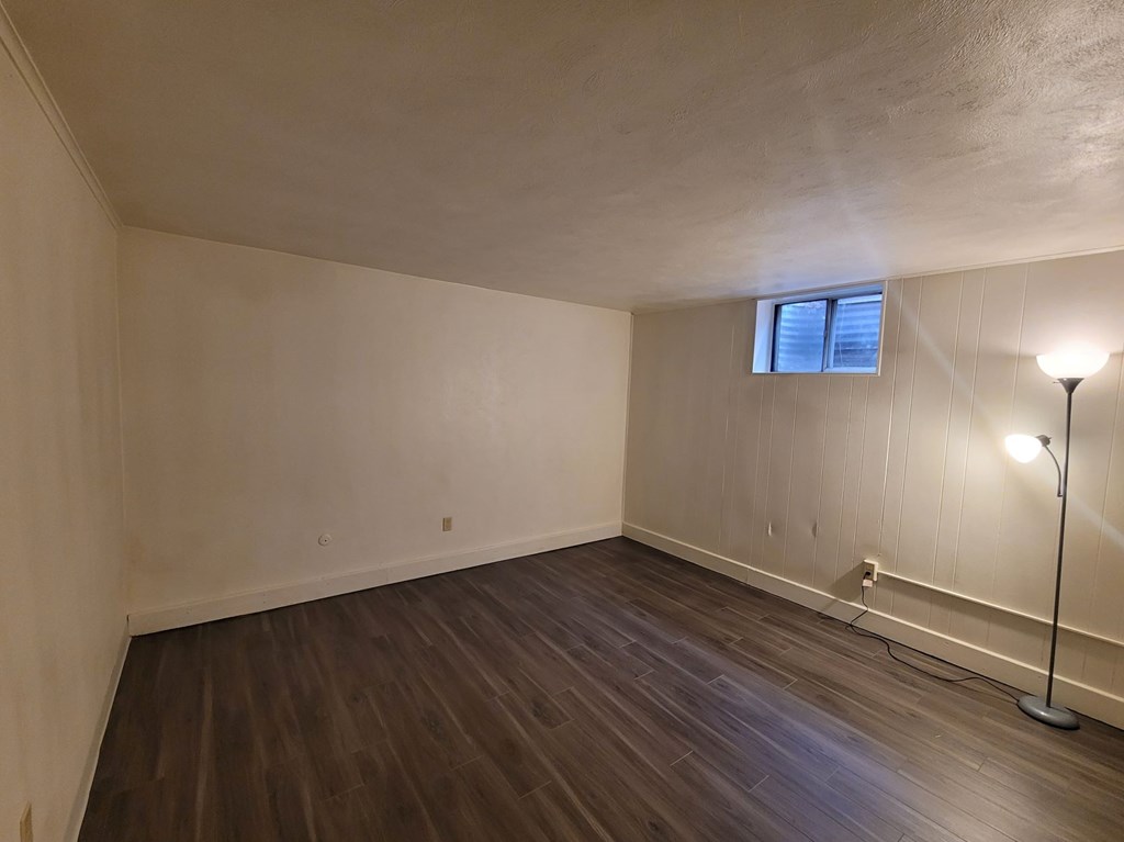 A room with wooden floors and a window.