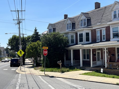 A stop sign is on the corner of a street.
