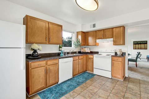 A kitchen with wooden cabinets and a white refrigerator.