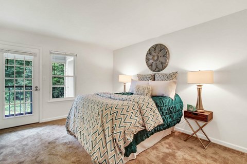 A bedroom with a large bed and a window.