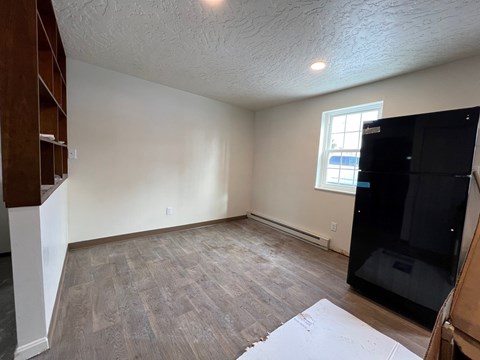 A room with a wooden floor and a window.