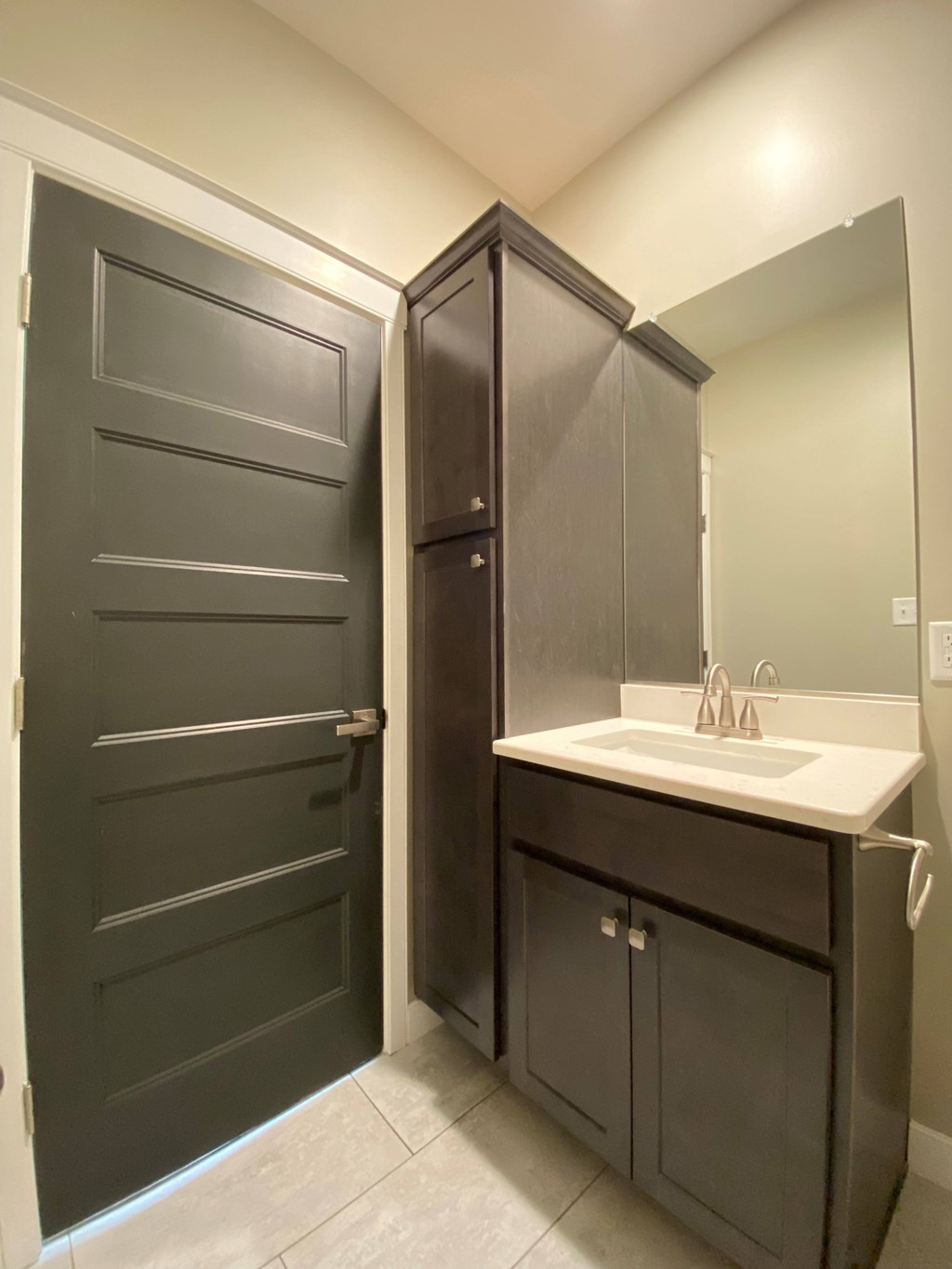 A bathroom with a sink and a door.