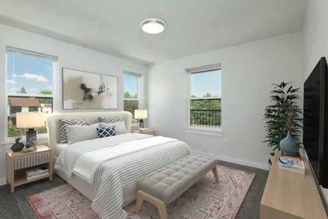 A bedroom with a large bed and a flat screen TV.