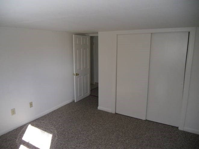 A room with a door and three panels on the wall.