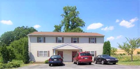 A house with two cars parked in front.
