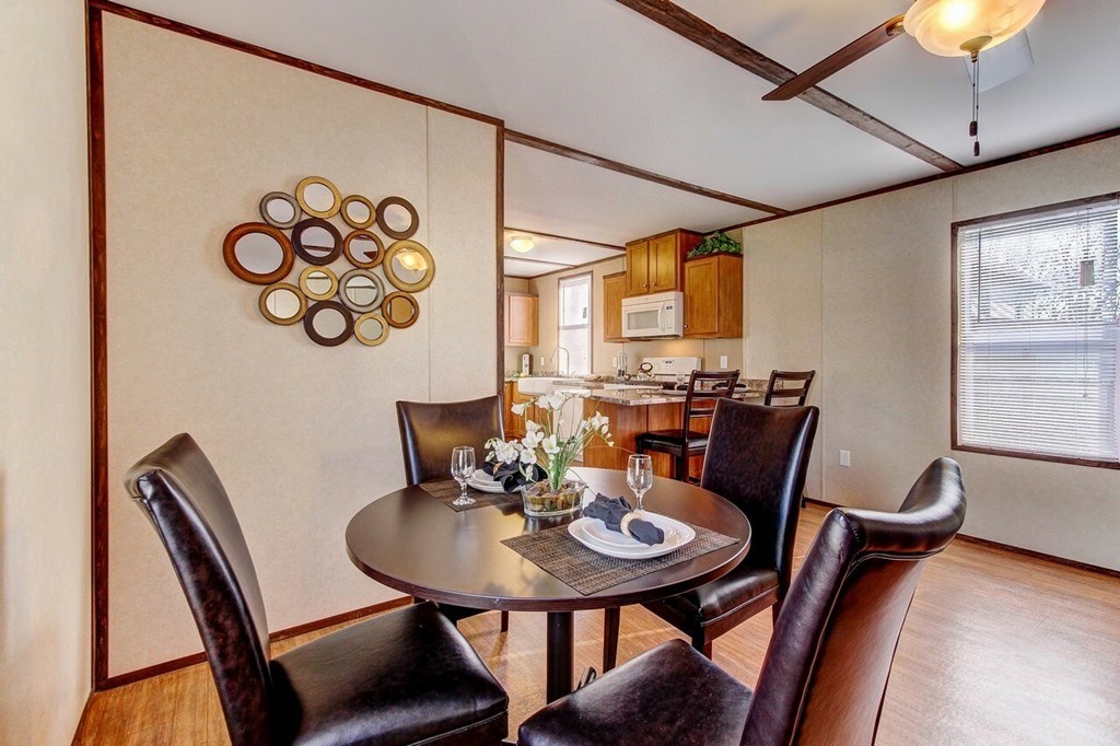 A dining room with a round table and chairs.
