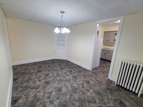 A room with a checkered floor and a chandelier.