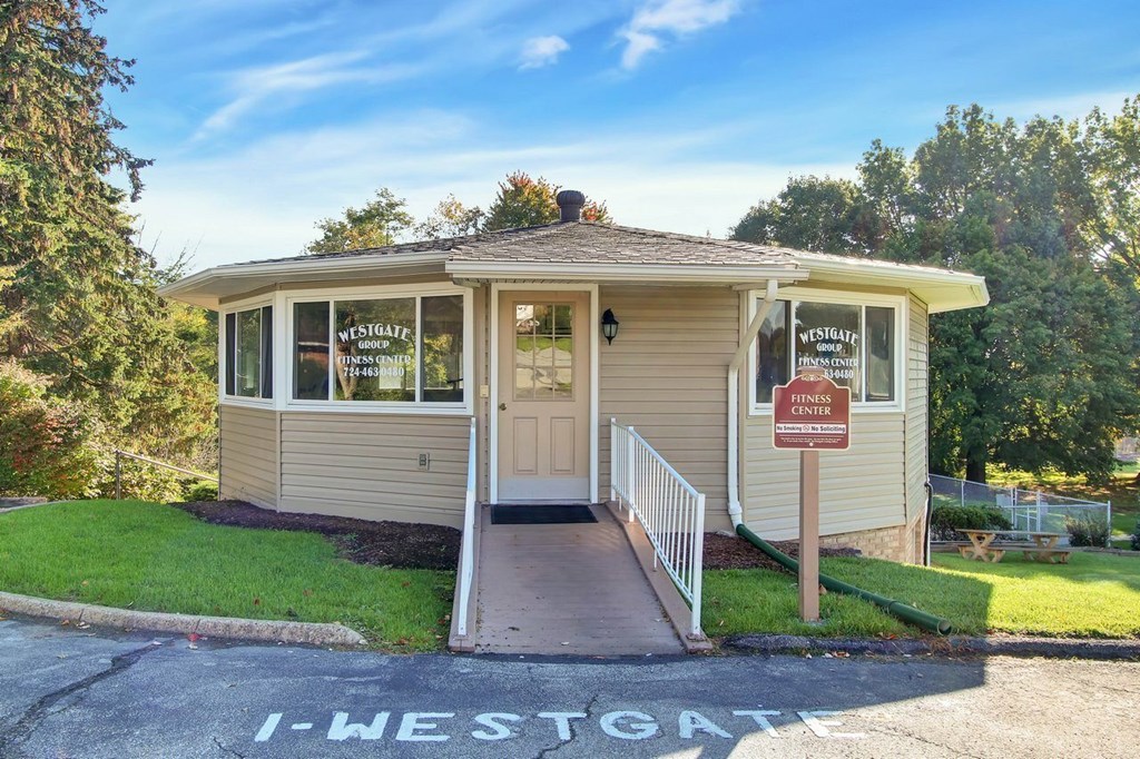 A small building with a sign that says Westgate in front of it.