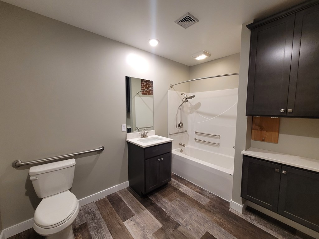 A bathroom with a toilet, sink, and bathtub.