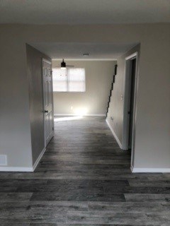 A long hallway with a light at the end.