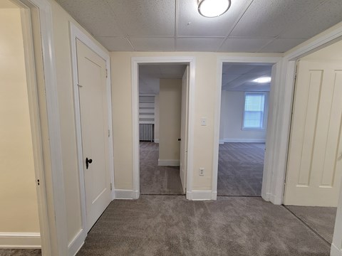 A room with white walls and carpeted floor.