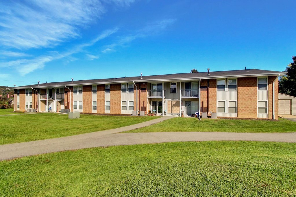 A long building with a lawn in front.