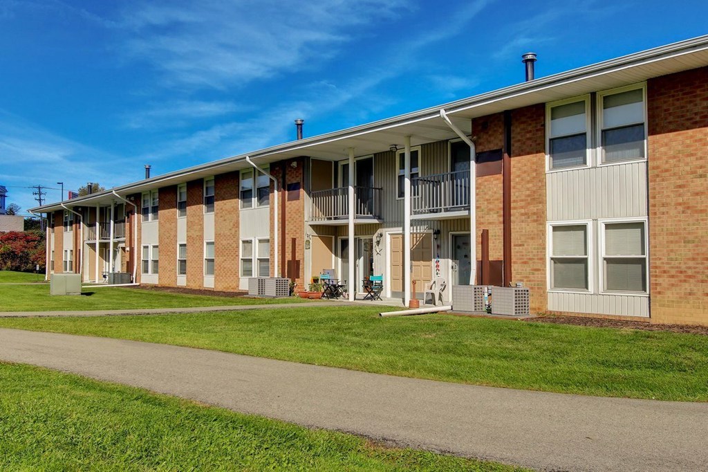 A row of apartment buildings with a clear blue sky above.