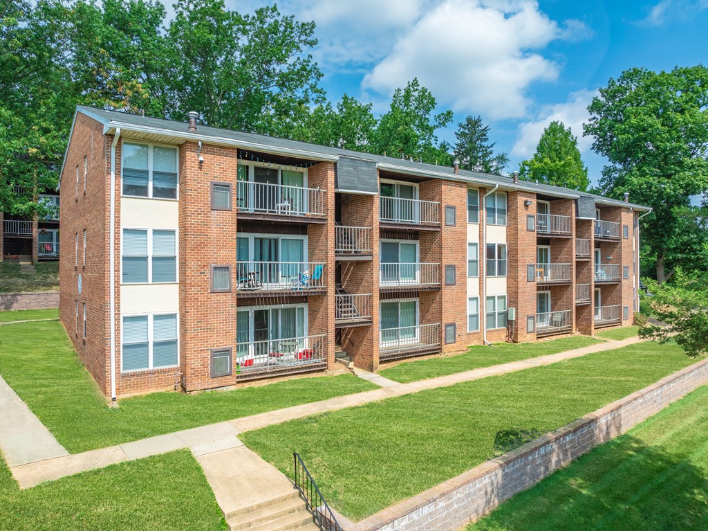 Apartment building with a green lawn in front.