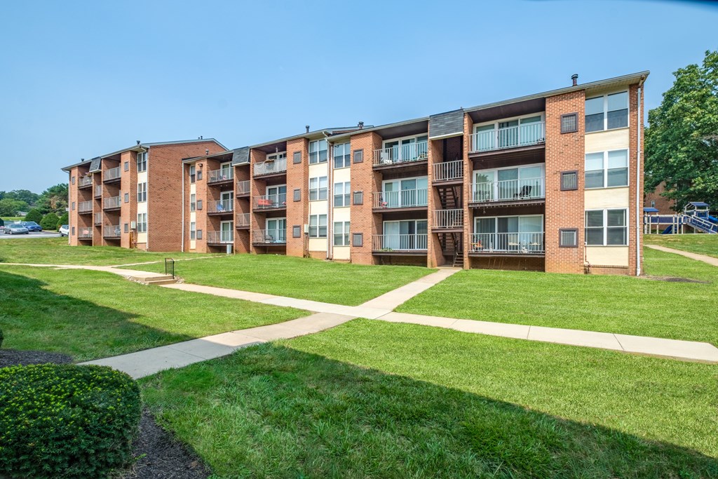 Apartment building with a green lawn in front.