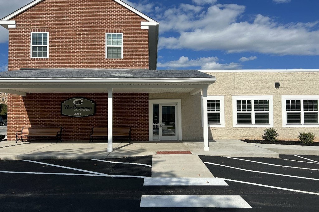 A brick building with a sign that says "The Community" on it.