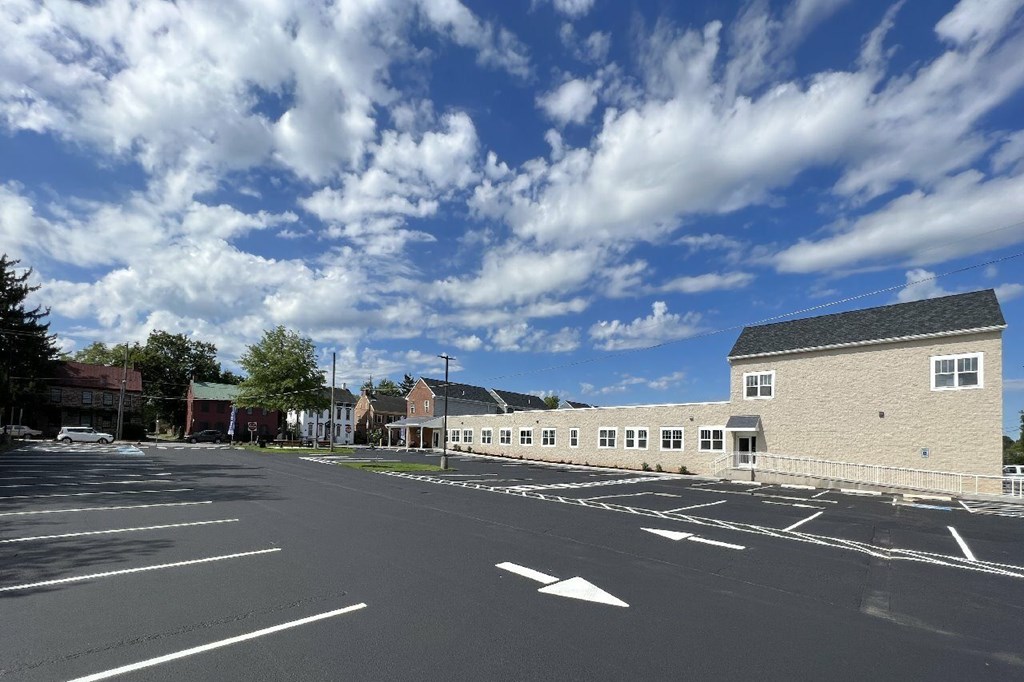 A parking lot with a building on the right side.