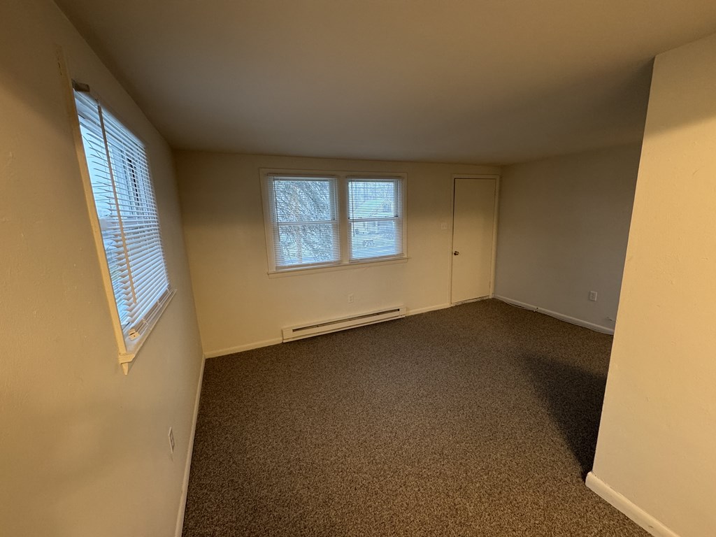 A room with a window and a door.