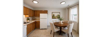A kitchen with a table and chairs and a painting on the wall.