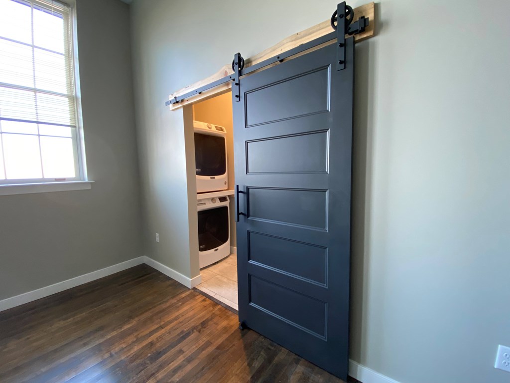 A room with a sliding barn door and a window.
