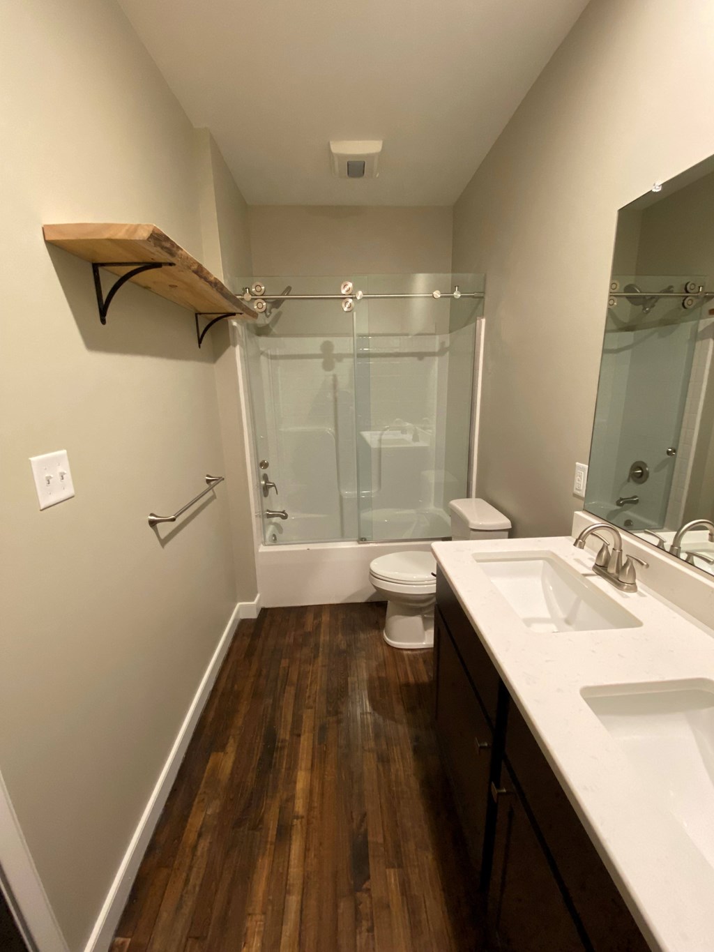 A bathroom with a toilet, sink, and shower.
