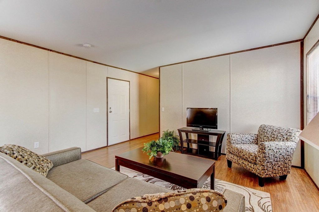 A living room with a couch, chair, and coffee table.