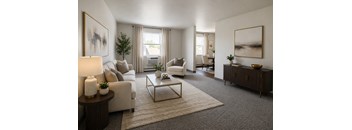 A living room with a white couch, a coffee table, and a painting on the wall.