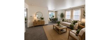 A living room with a couch, chair, and coffee table.