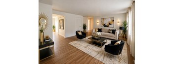 A living room with a black and gold coffee table and a black chair.
