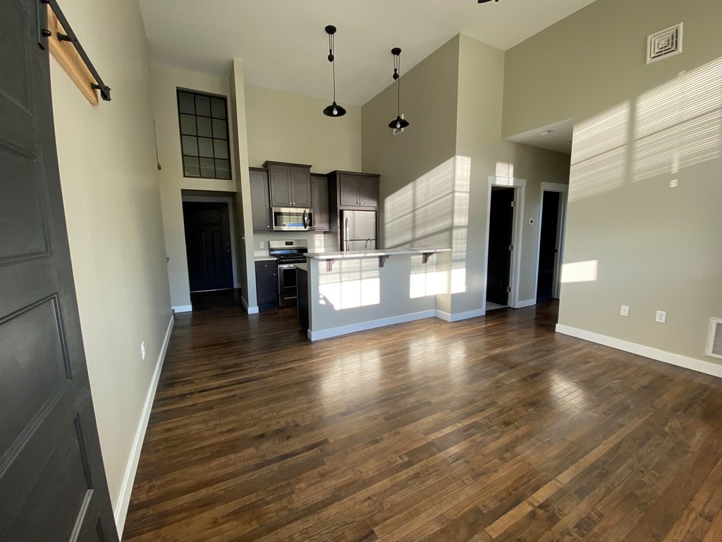 A kitchen with a wooden floor and a countertop.