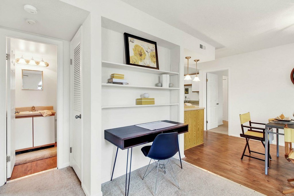 A room with a black table and blue chairs.