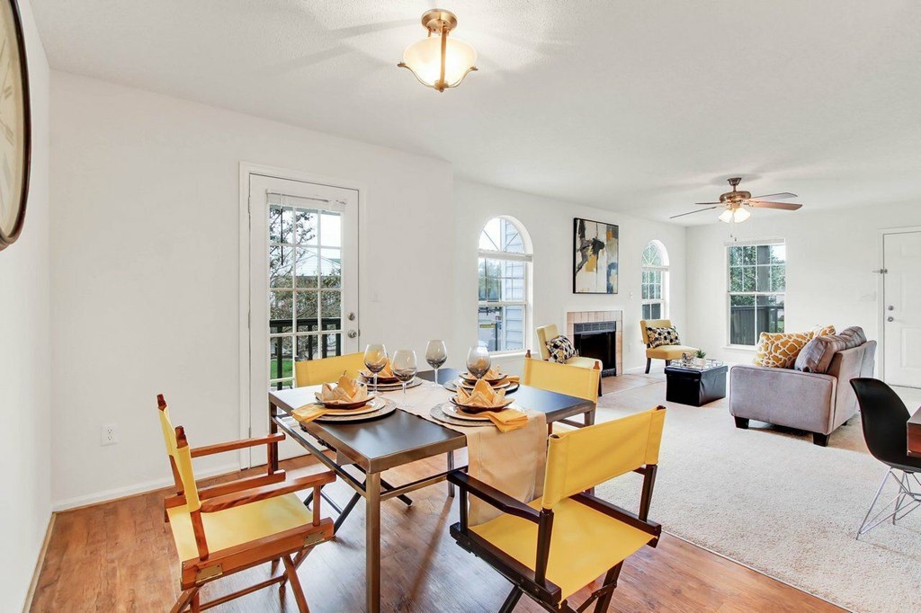 A dining room with a table set for a meal.