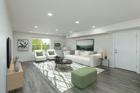 A modern living room with a green ottoman and a white couch.