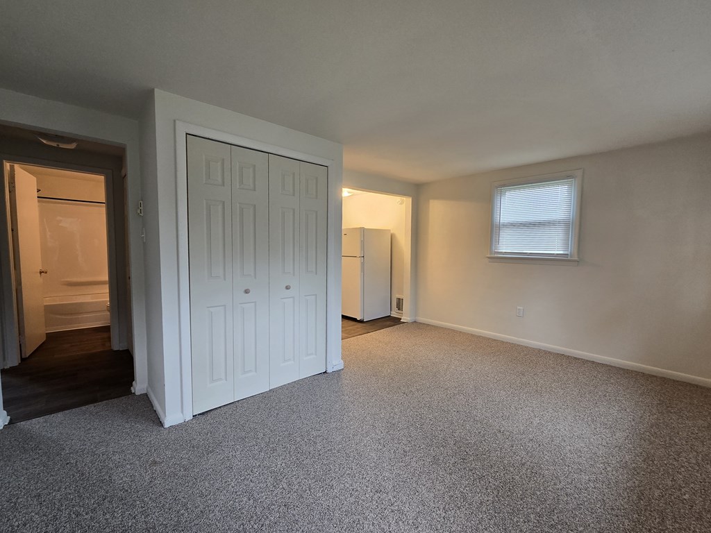 A room with a white door and a window.