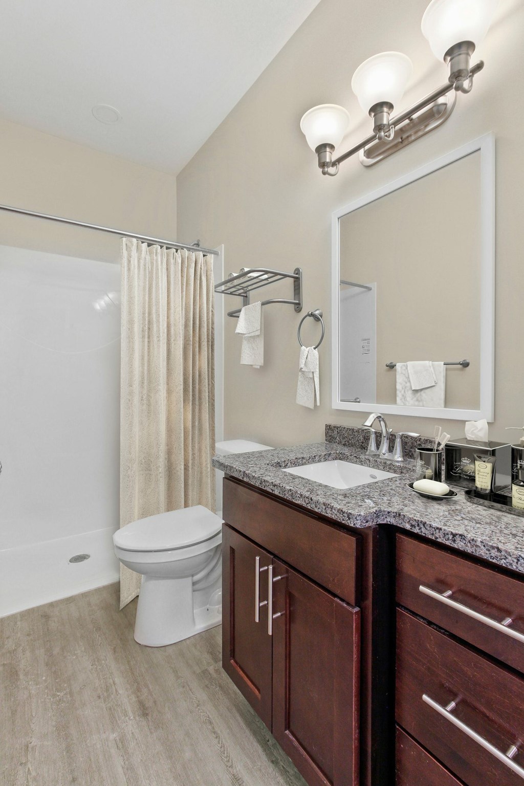 A bathroom with a white toilet and a large mirror.