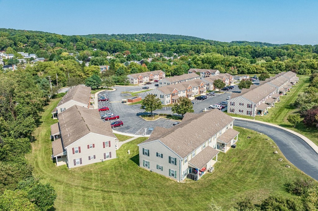 A large white building with a parking lot in front of it.