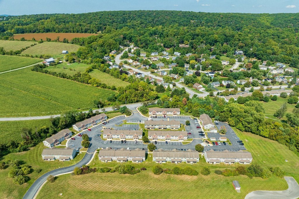 A bird's eye view of a residential area with houses and roads.